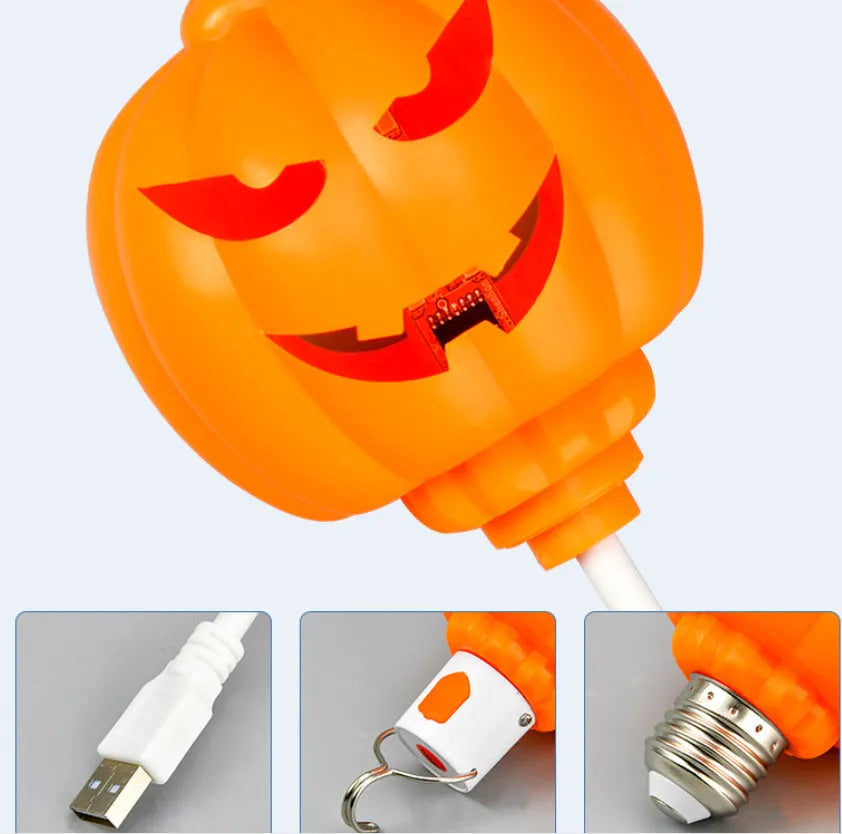 A plastic pumpkin lamp with a USB port, glowing in either yellow or purple light.