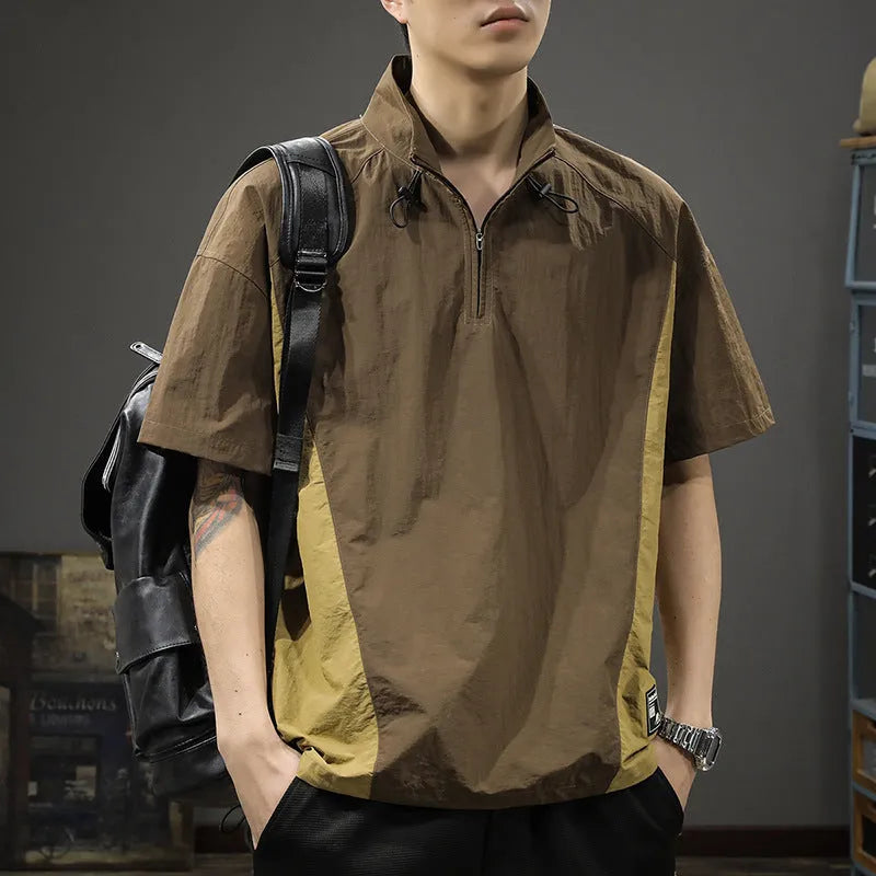 A brown men's loose-fit short-sleeve shirt with a half-zip front and stand collar.