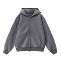 Woman wearing a distressed grey fleece-lined hooded cardigan with patch pockets.