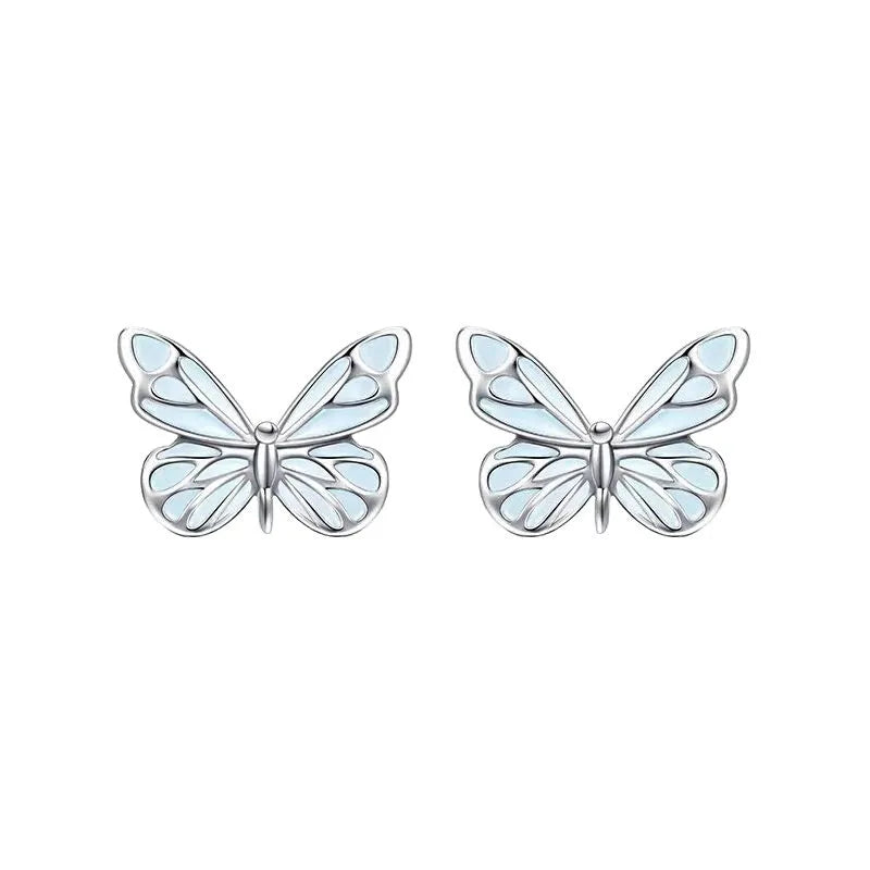 Set of 925 silver luminous butterfly bracelet necklace and earrings with floral petals on white background