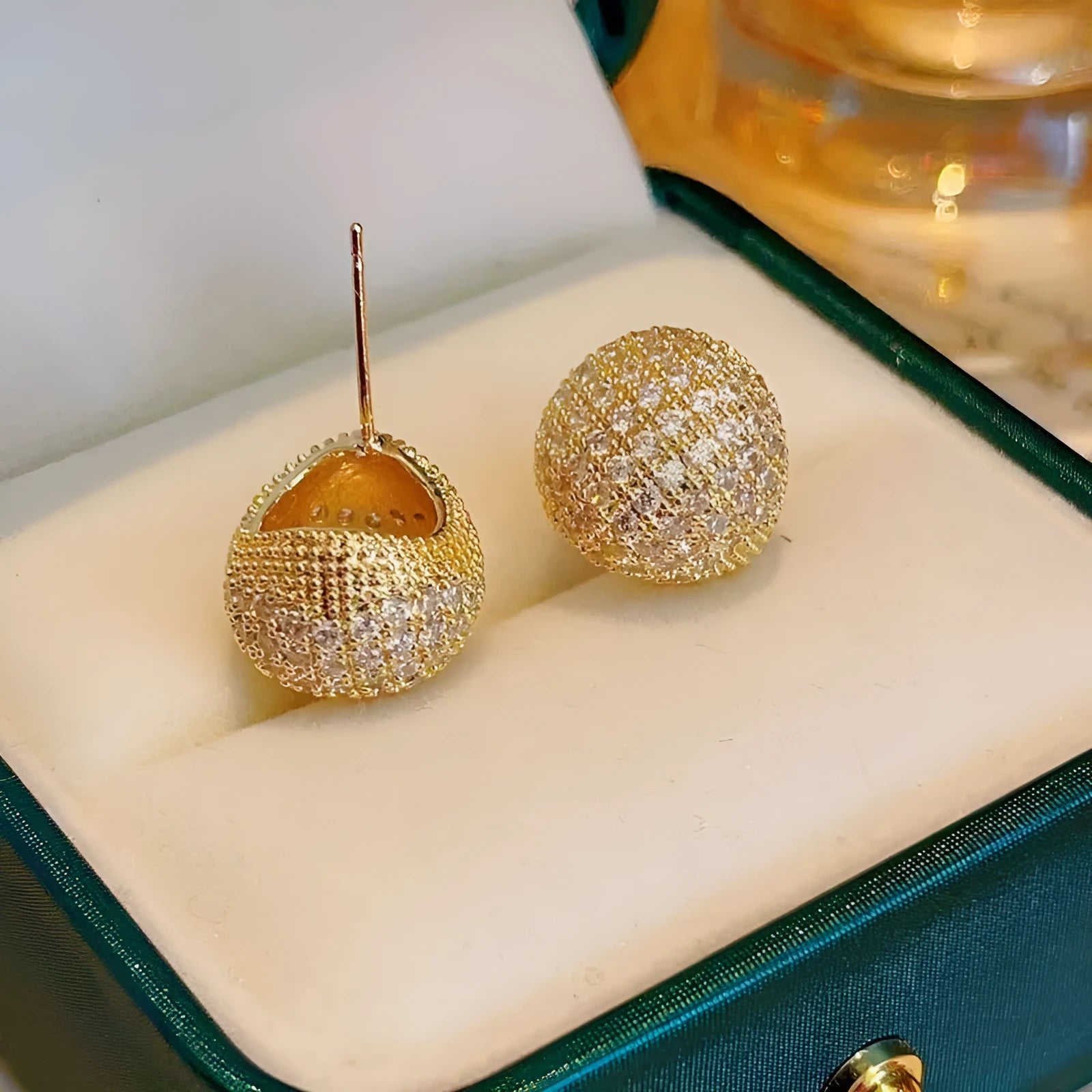 Women's gold and white drop-shaped ear clip earrings with full diamond embellishment and geometric golden beans design