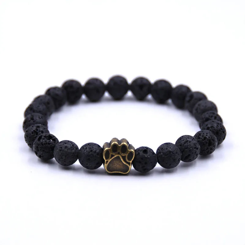 Natural stone dog paw bracelet with tiger eye beads and gold finish on a neutral background