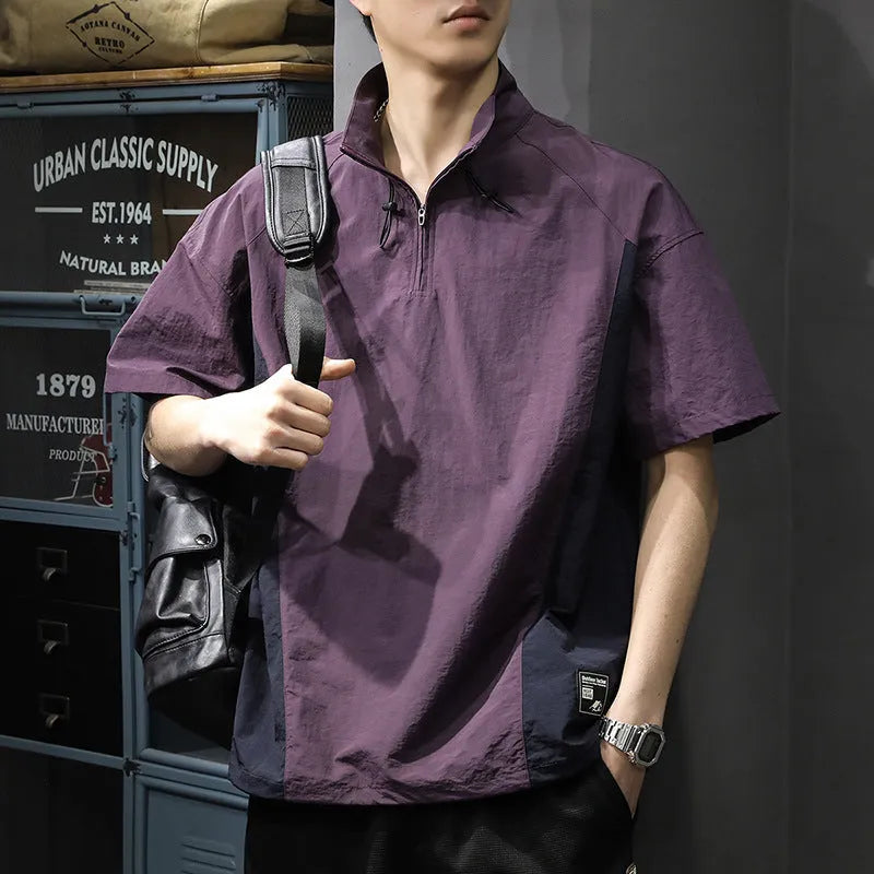 A brown men's loose-fit short-sleeve shirt with a half-zip front and stand collar.
