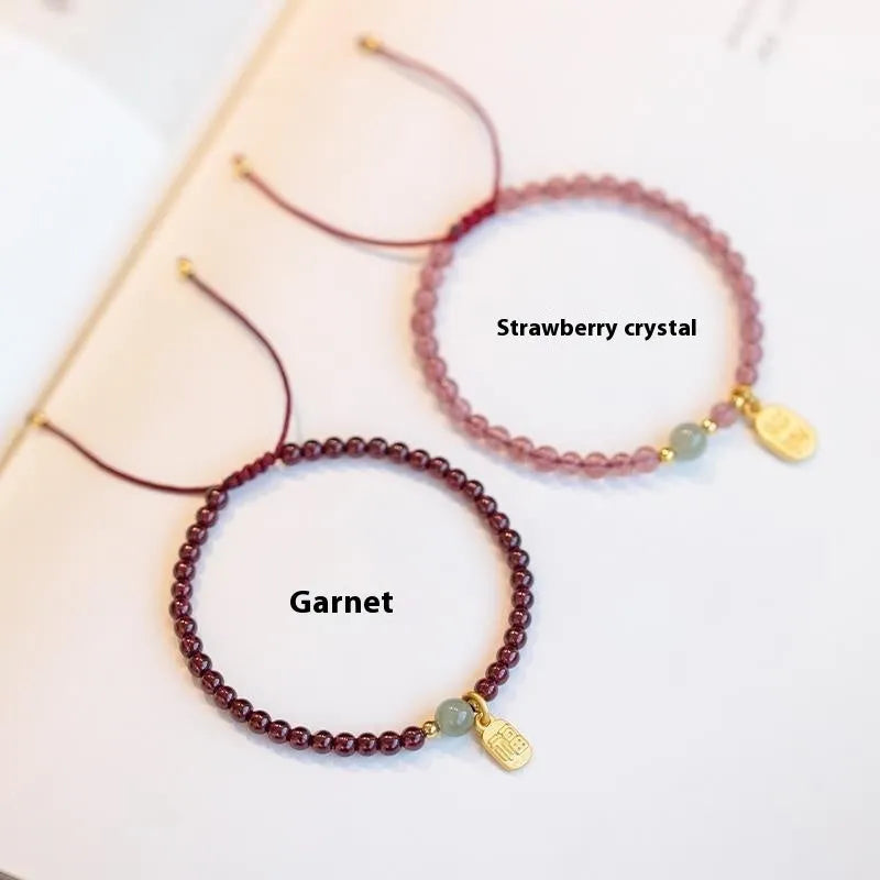 Hand-woven red rope bracelet with strawberry quartz crystal lucky charm