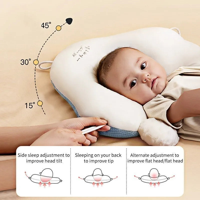 Blue and white U-shaped baby head shaping pillow made of pure cotton on a neutral background.