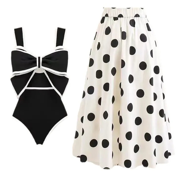 Women's black one-piece swimsuit with white round skirt and bow detail for swimming