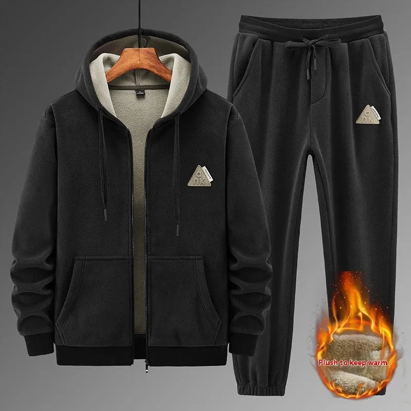 Grey men's casual sports suit with hooded sweater and matching trousers laid flat.