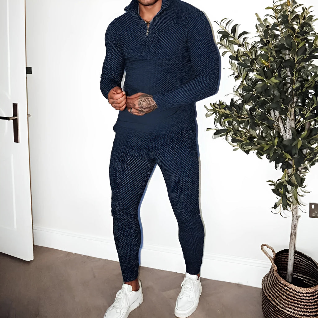 Men's grey sports and leisure loose suit set with polyester top and pants on a plain background