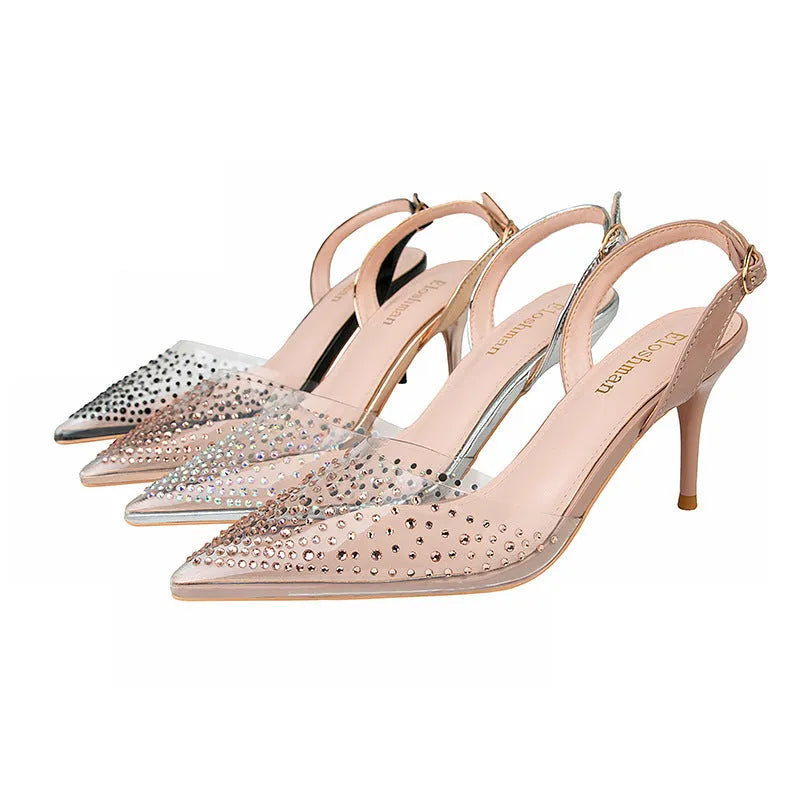 Women's black pointed low-cut stiletto high heels with buckle closure on a light background