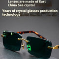 Green frameless reading glasses with dark tinted lenses on protective case