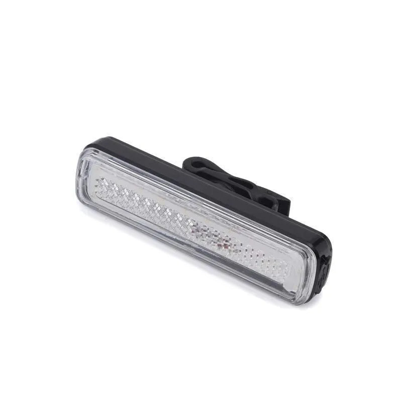 USB rechargeable bicycle light with colourful LED on a bicycle handlebar at night
