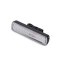 USB rechargeable bicycle light with colourful LED on a bicycle handlebar at night