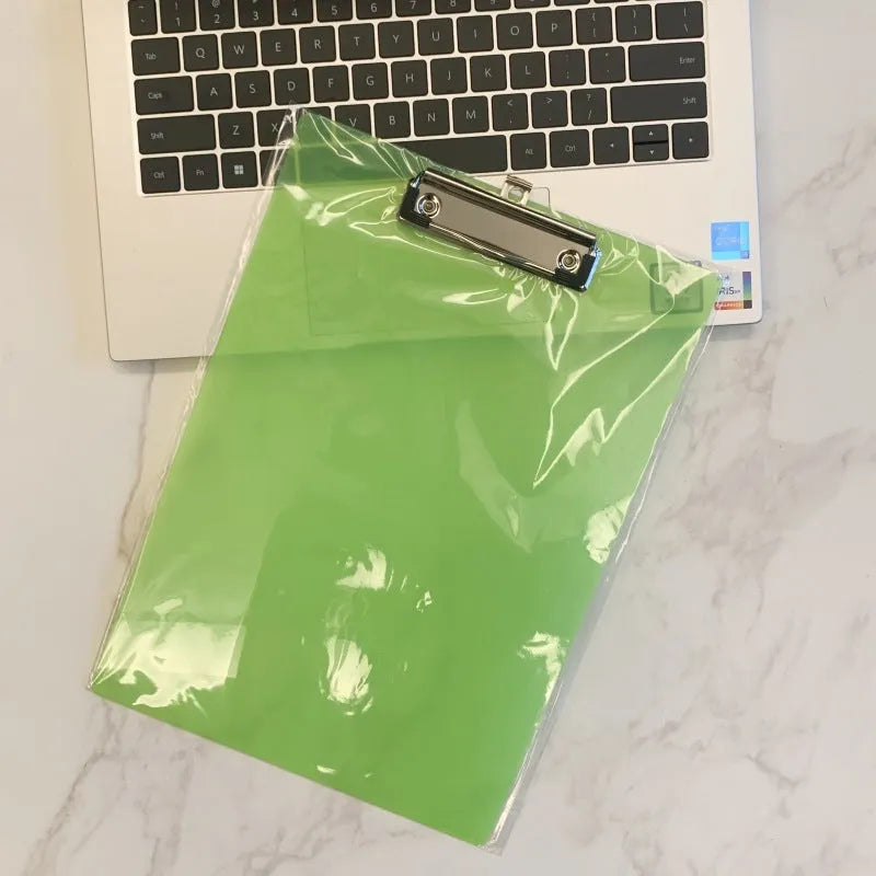 A4 transparent polypropylene clipboard with metal clip, shown in blue, holding paper.