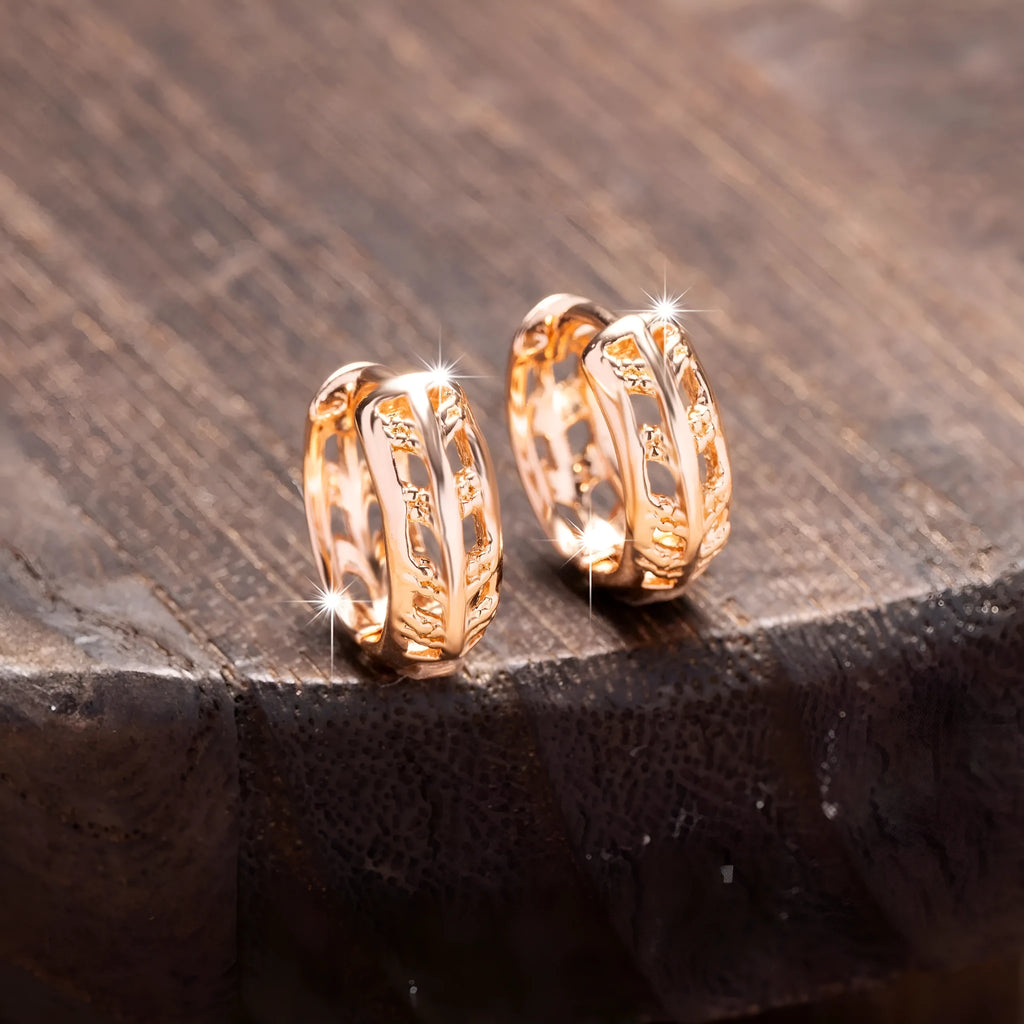 Hollowed-out copper earrings with leaf and heart designs in rose gold colour