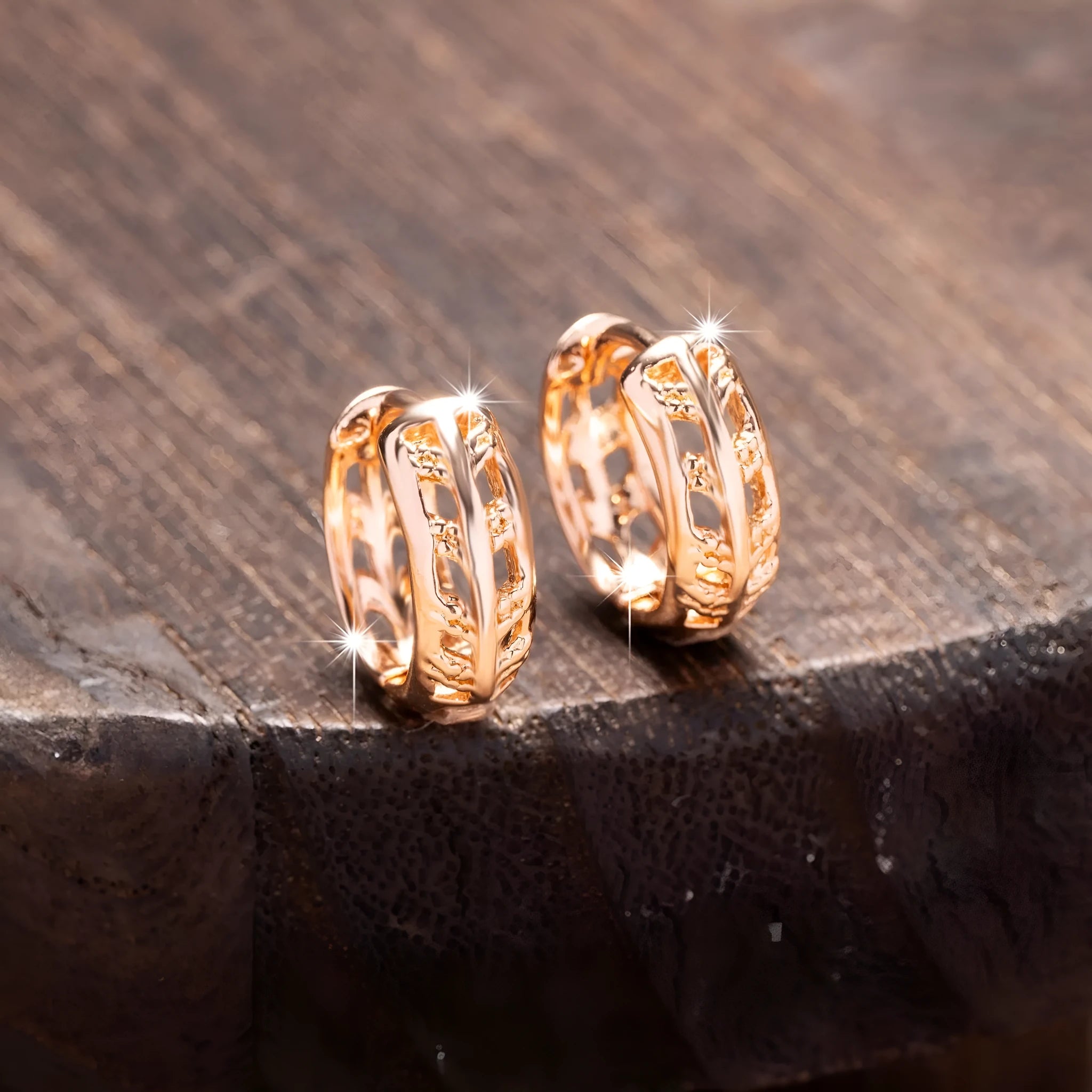Hollowed-out copper earrings with leaf and heart designs in rose gold colour