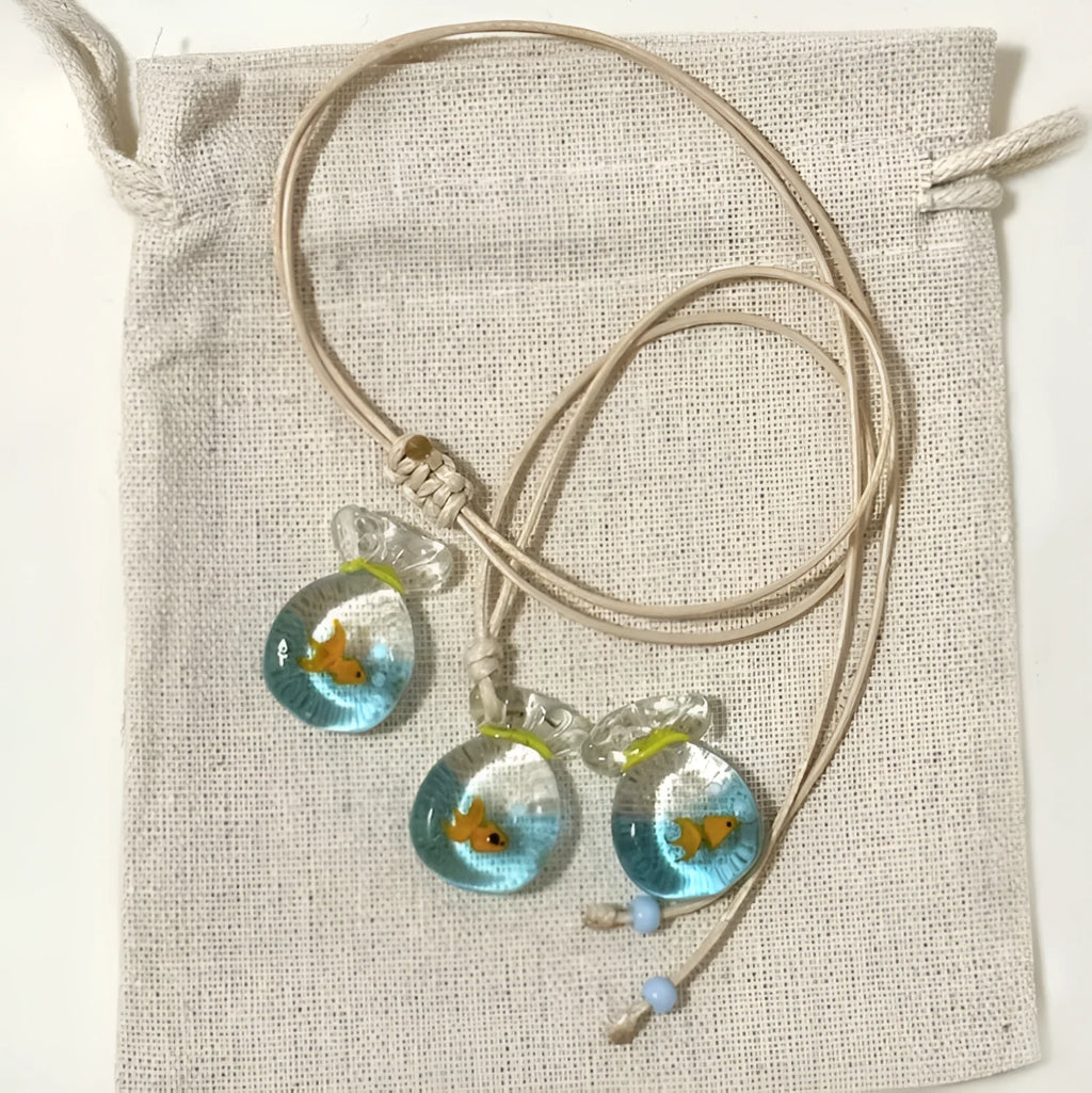 Women's pendant necklace with coloured glaze charm on a cotton and linen clavicle chain in Small Fish Lucky Bag colour.