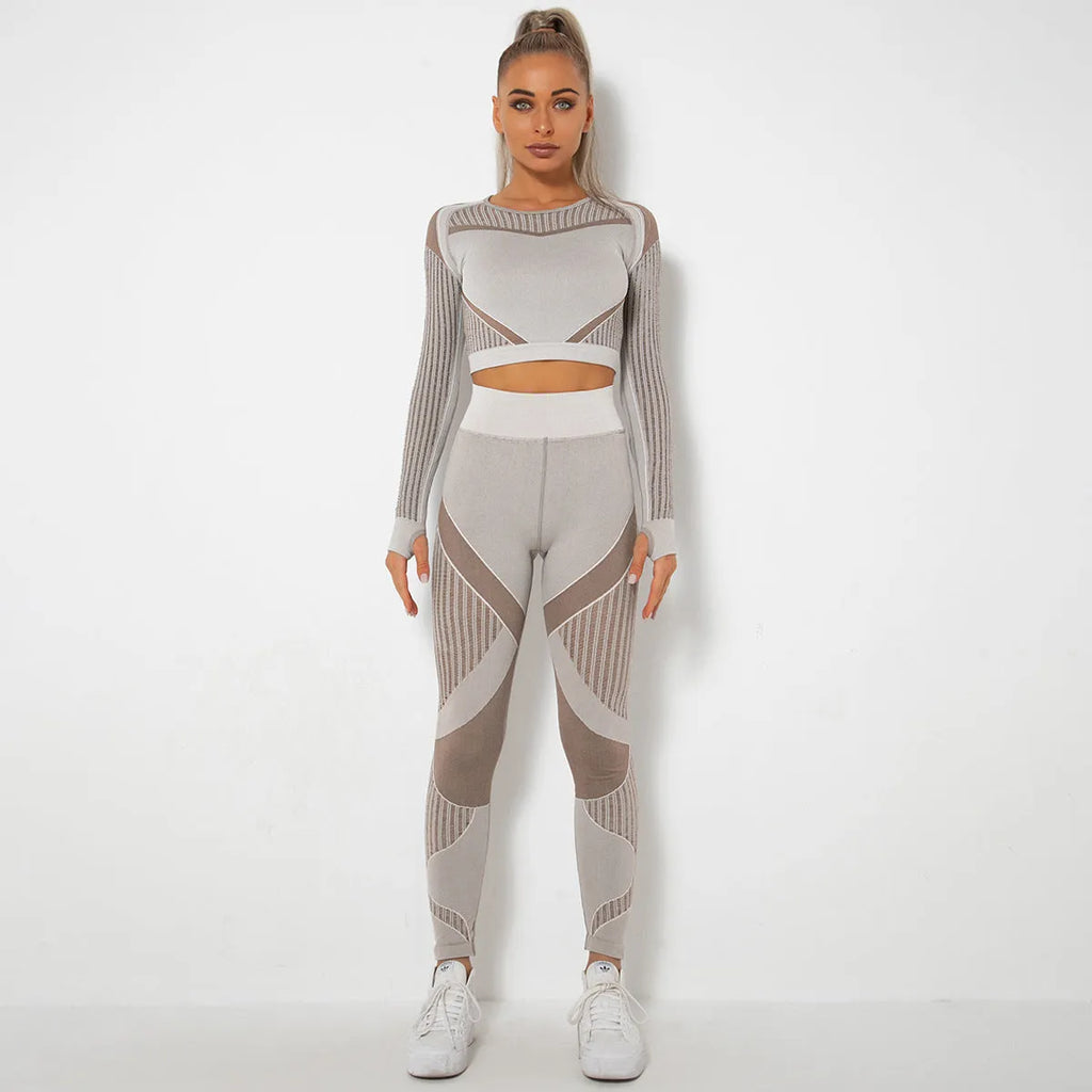 Woman wearing a seamless long-sleeved yoga suit in a neutral colour, demonstrating a stretch pose.