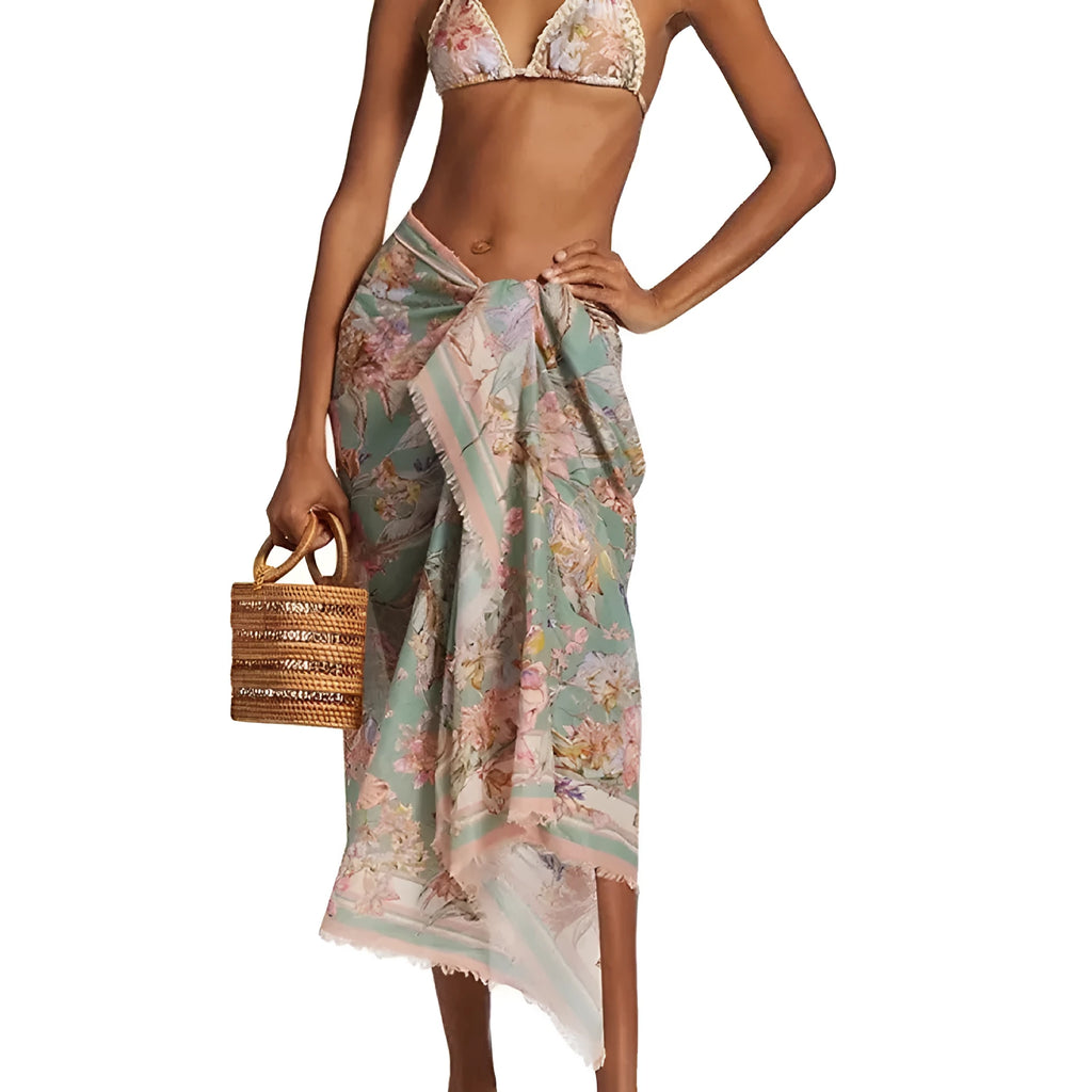 Women's creamy white floral bikini set with top, briefs, and matching skirt on a mannequin.