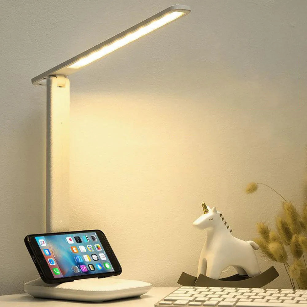 White plastic touch dimming bedside lamp with USB charging cable.