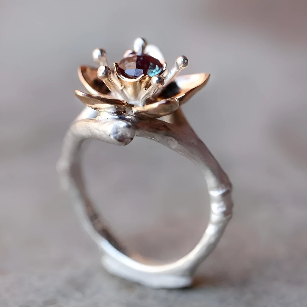 Silver two-tone floral geometric women's ring on display showing geometric shape and floral pattern detail.