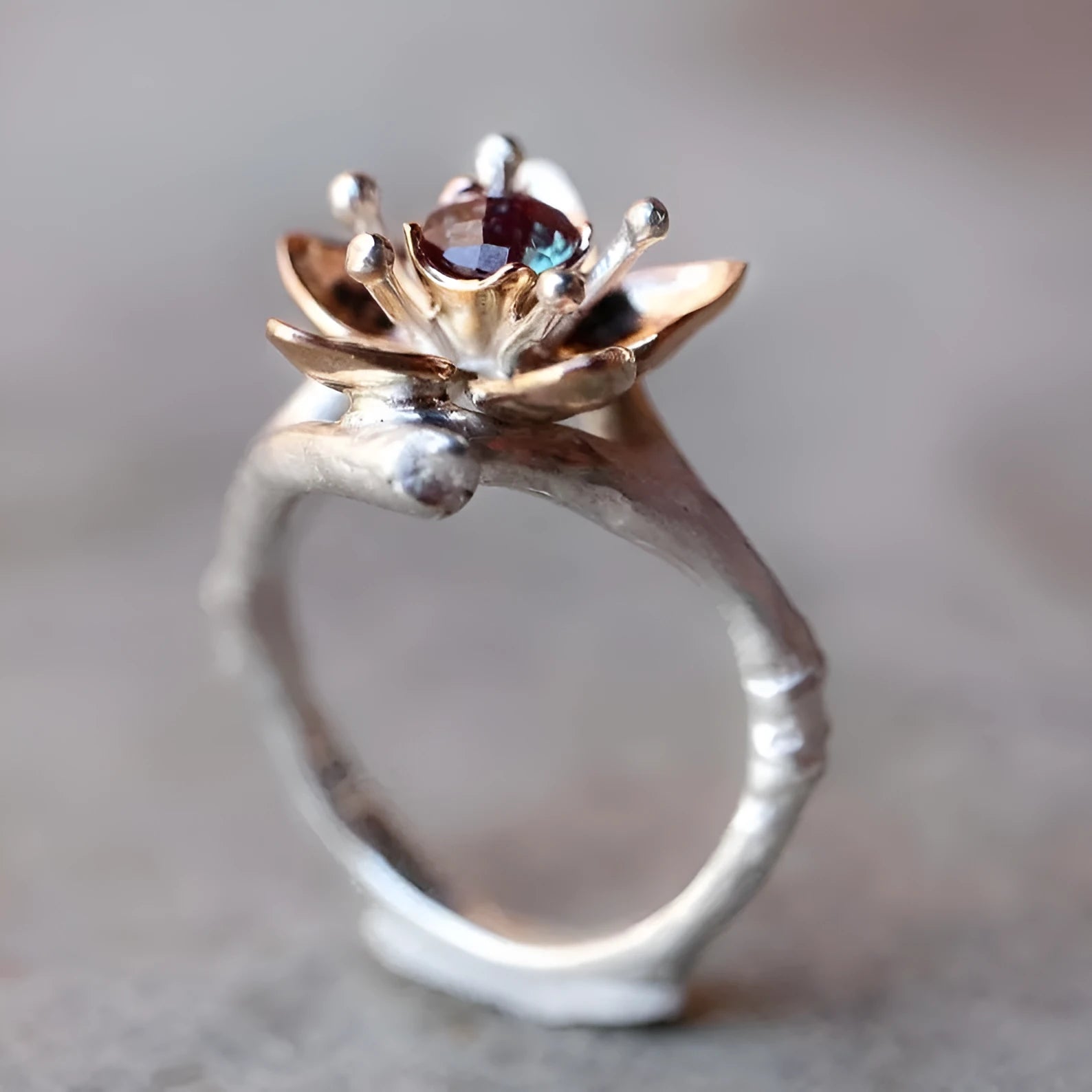 Silver two-tone floral geometric women's ring on display showing geometric shape and floral pattern detail.