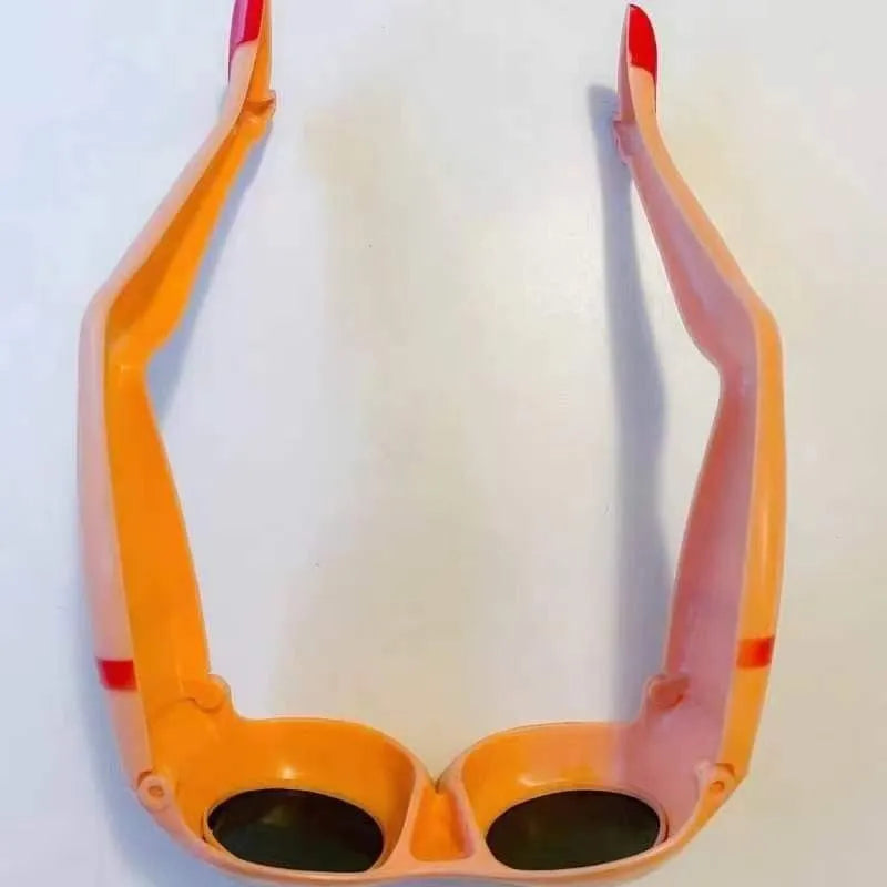 Orange plastic novelty sunglasses with personality leg hip design, dimensions 15x20cm
