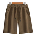 Men's straight-cut cotton summer shorts in light grey, showing fifth-pant length and casual style.