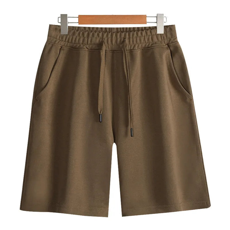 Men's straight-cut cotton summer shorts in light grey, showing fifth-pant length and casual style.