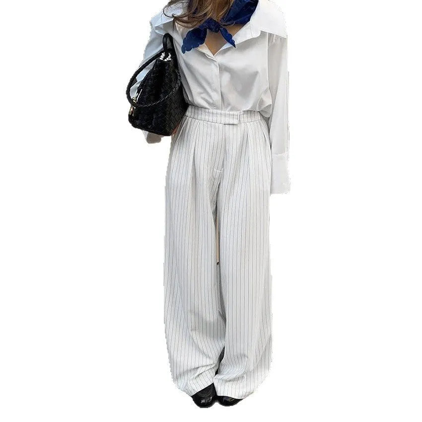 White striped wide-leg casual trousers with zipper detailing on a mannequin.