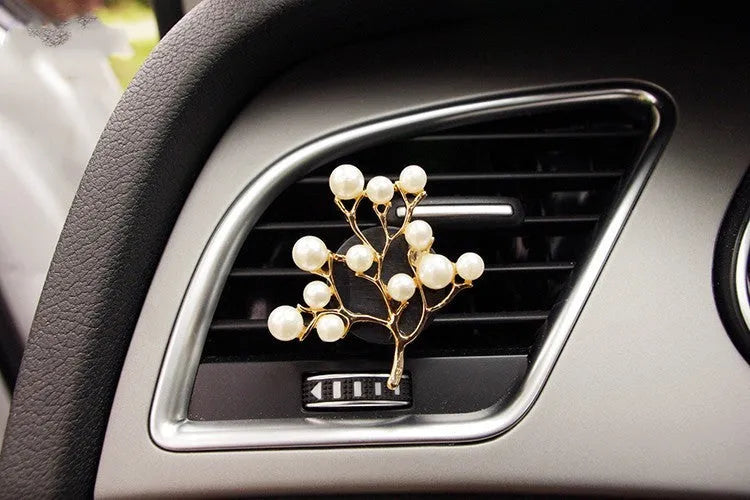 Alloy car perfume clip with liquid fruity scent attached to air vent in various cartoon styles