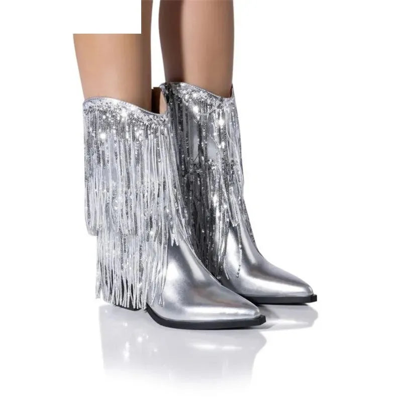 Women's black chunky heel tassel boots with pointed toe and high stiletto, shown on a model.