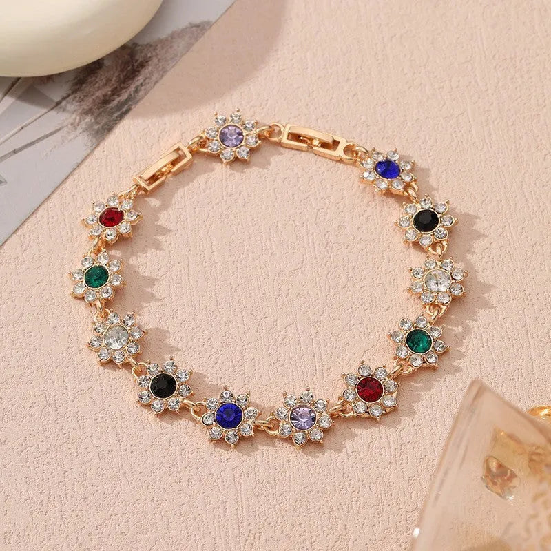 Electroplated zinc alloy floral bracelet showing colour variations including gold and silver tone options
