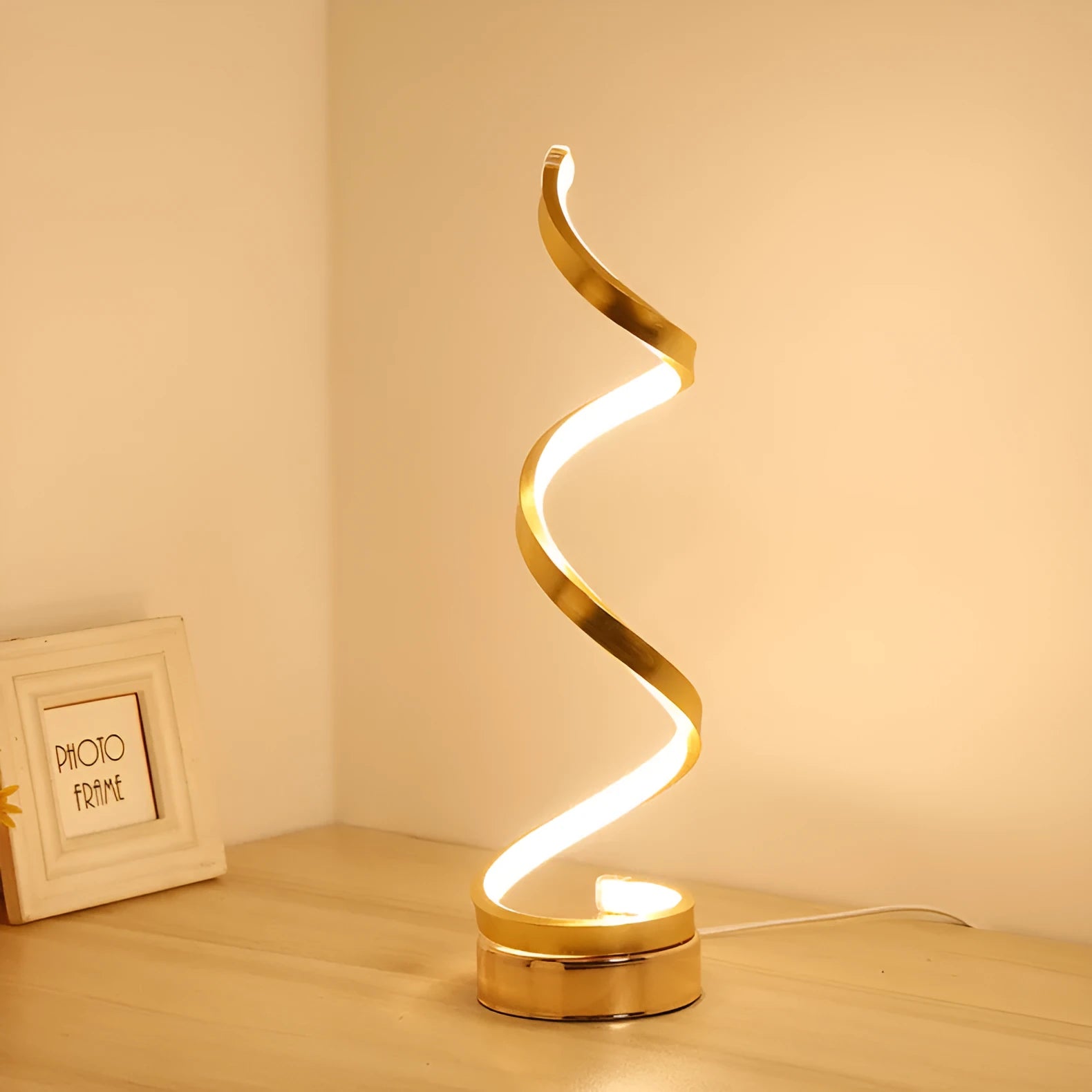 Black and white minimalist LED table lamp with aluminium shade on a desk.
