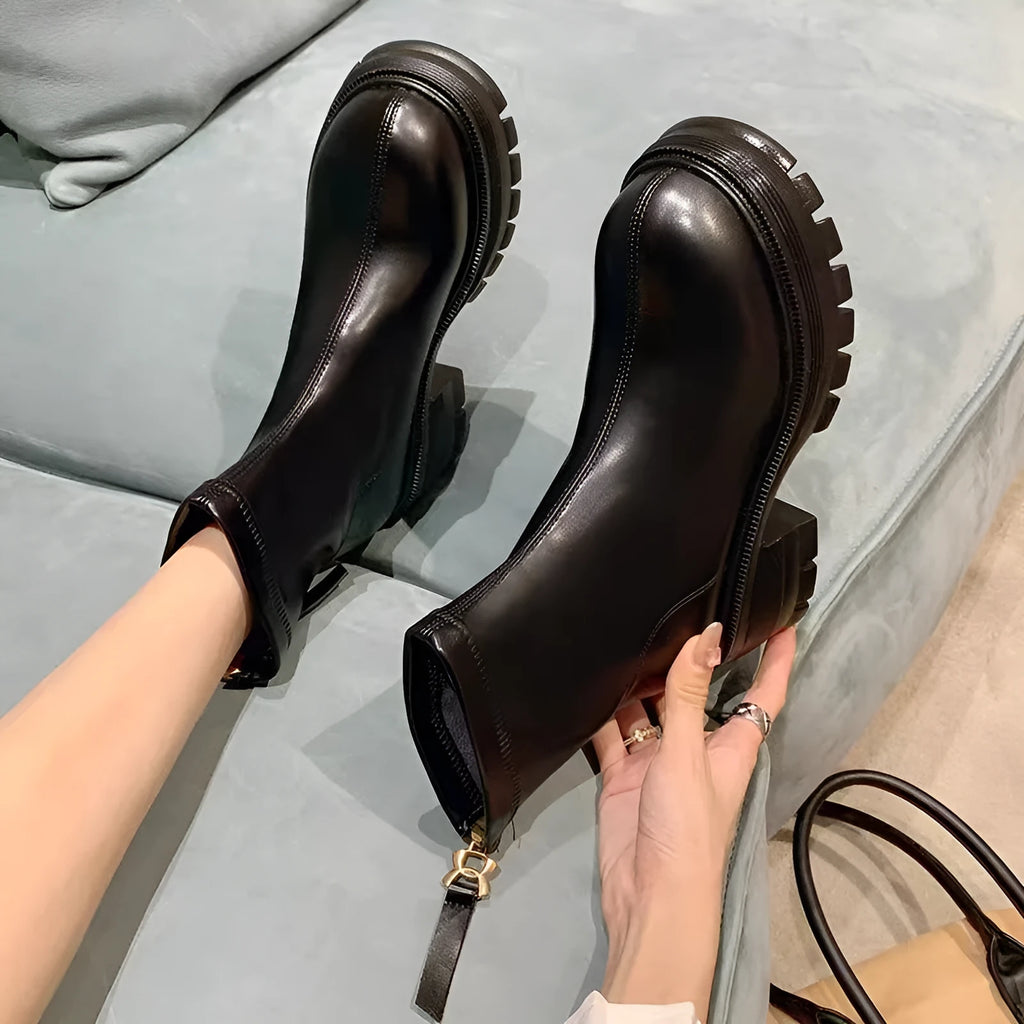 White platform ankle boots for women with thick foam rubber sole, mid-calf shaft, square heel, round toe, and back zipper.