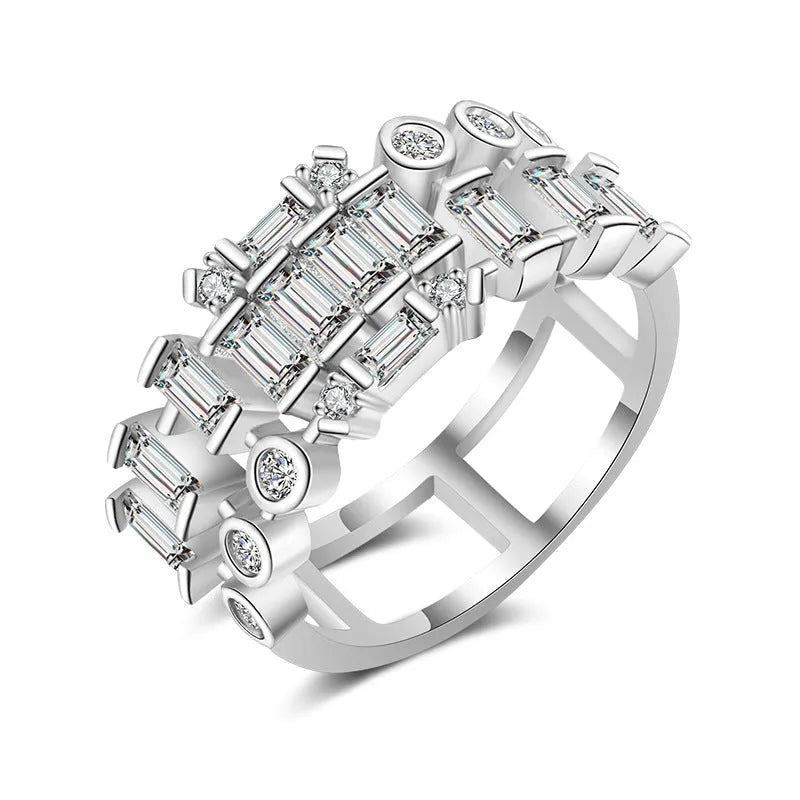 Gold-plated copper ring with hollow geometric setting and inlaid zircon stones