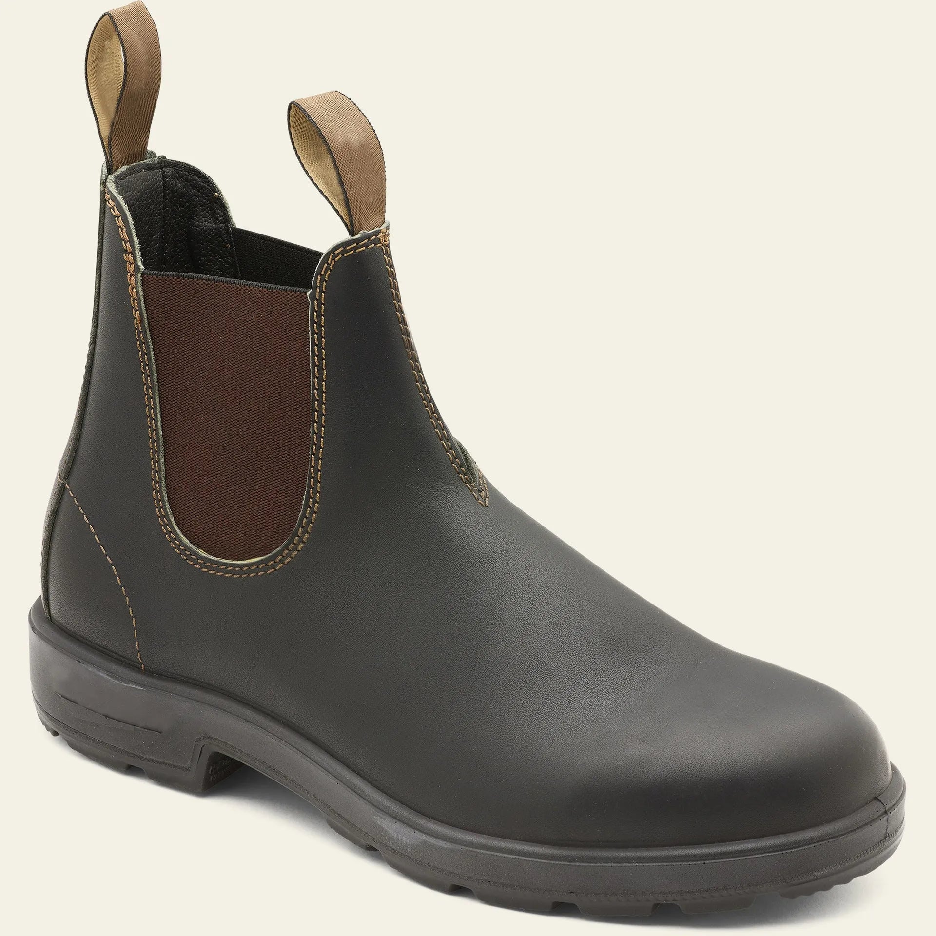 Vintage brown Chelsea boots with frosted PU upper and round toe on wooden floor
