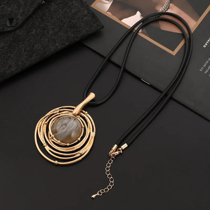 Gold geometric pendant sweater chain necklace with snakeskin texture rope on model