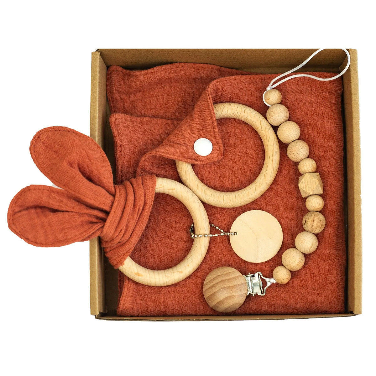 Baby teething toy gift set with bamboo blend gauze blanket, wooden beech bell, teether, brush, and milestone marker.