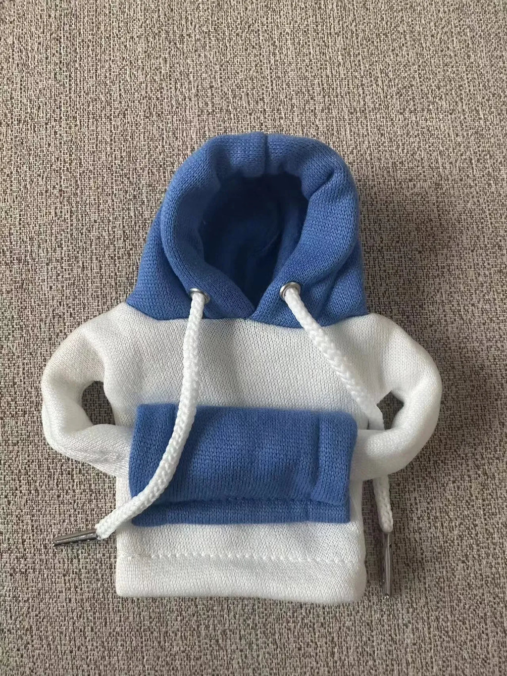 Polyester knit hooded cover stretched over a car manual gear lever in a red and white colour combination.