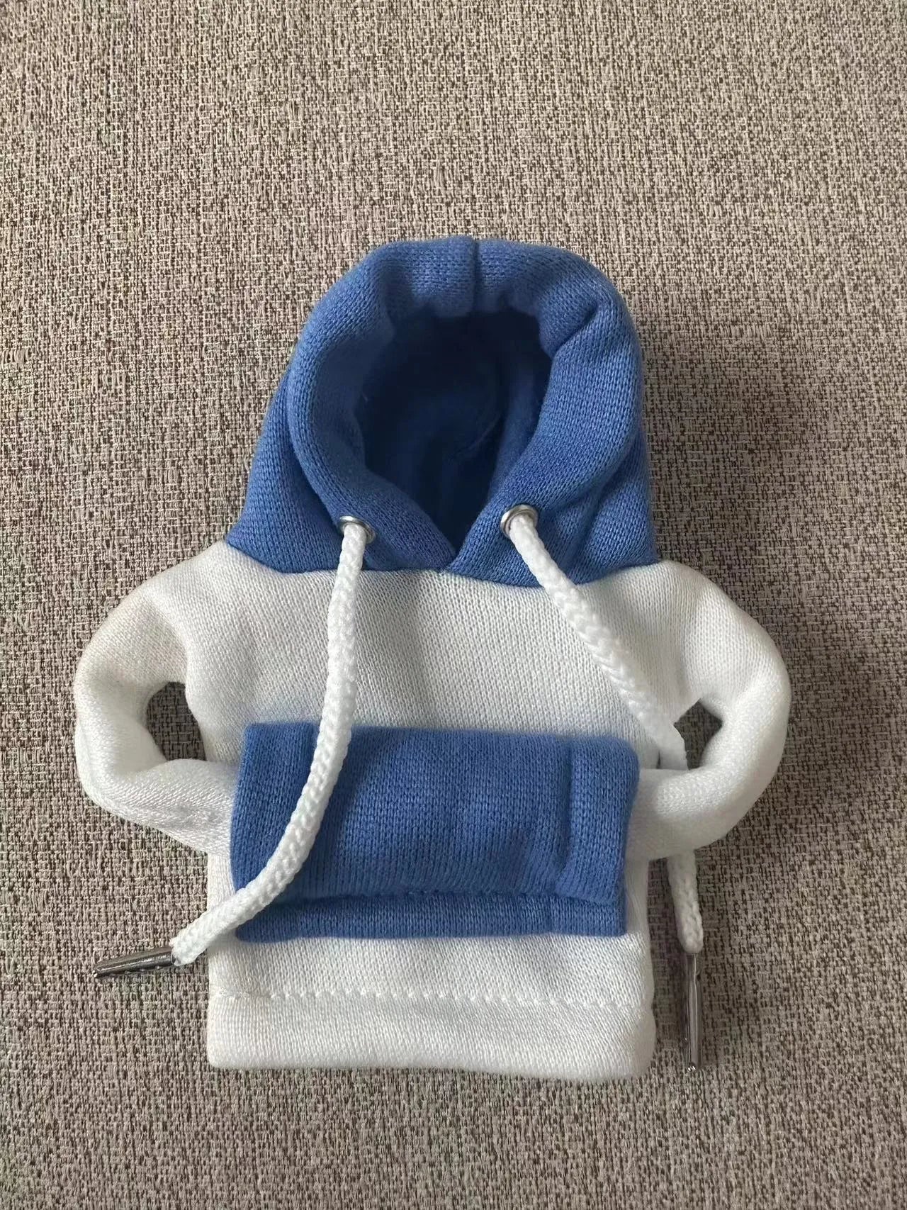 Polyester knit hooded cover stretched over a car manual gear lever in a red and white colour combination.