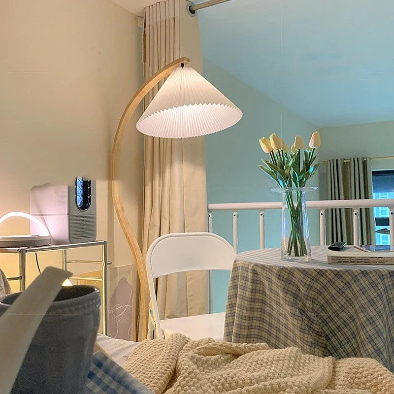Vertical retro table lamp with a choice of log white or wine red lampshade on a wooden surface.