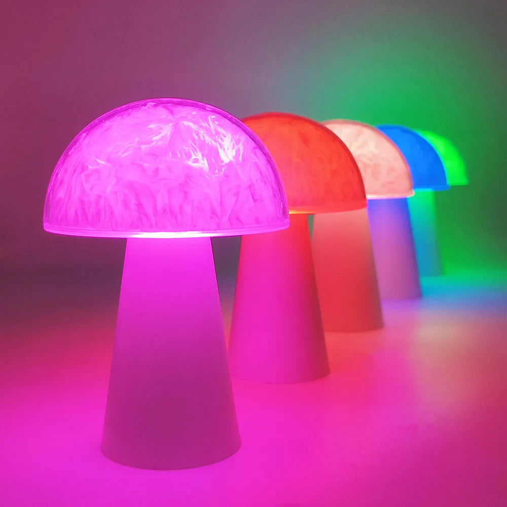 Mushroom-shaped RGB night light with remote control on wooden surface