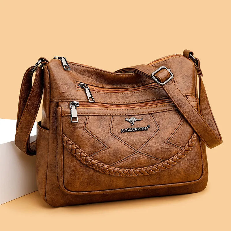 Soft PU leather women's shoulder bag in black colour showing crossbody strap and exterior pockets