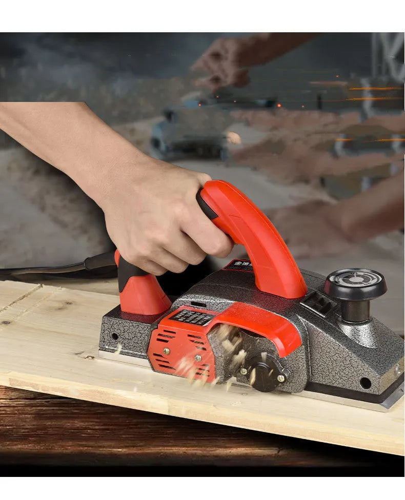 Red desktop electric wood planer with aluminium body, showing 82mm planing width