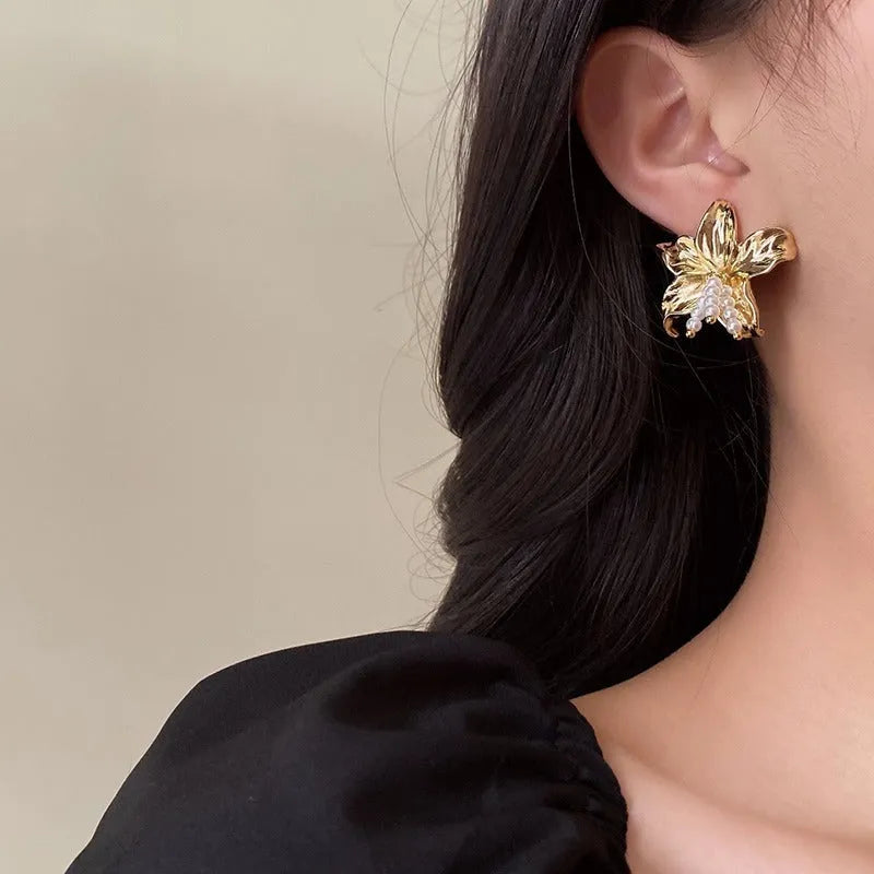 Exaggerated gold H1795 pearl flower earrings with Seiko crystal treatment, showing floral design.