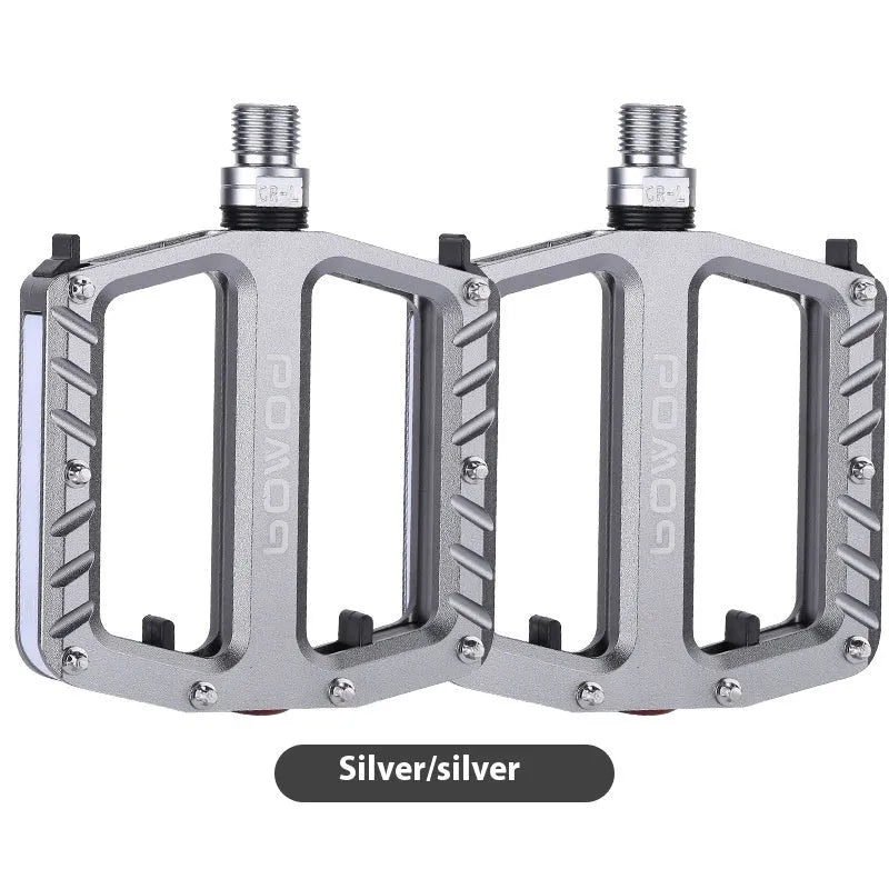 Aluminium alloy bicycle pedals with built-in 710LED lights in black, gold, purple, red, and titanium colour options.