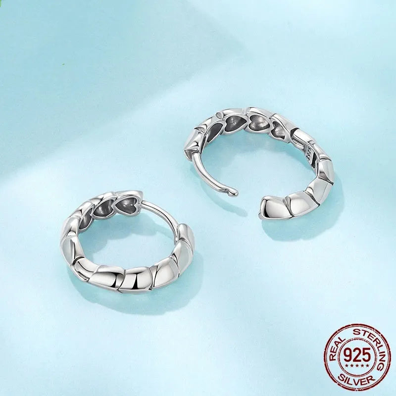 S925 sterling silver loving heart splicing ear clip with polished finish on white background