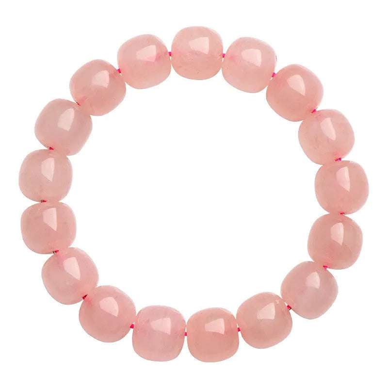 Pink crystal barrel-shaped bead bracelet on a wrist, showing geometric beads and polished finish.