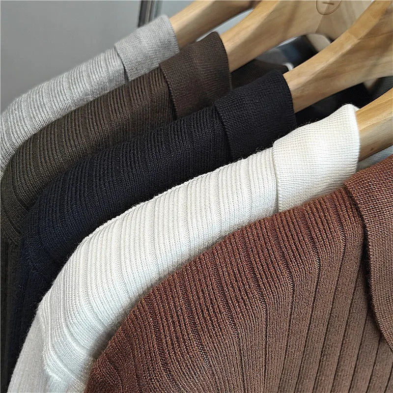 Men's loose grey knitted pullover sweater with long sleeves on a hanger.