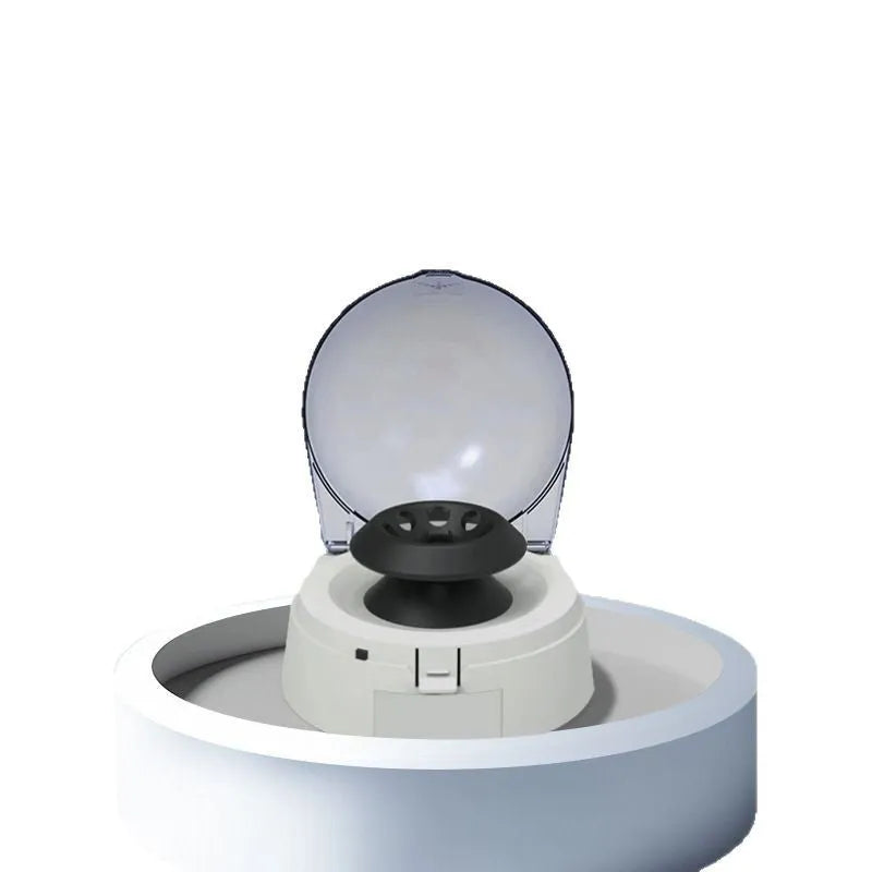 Mini laboratory electric centrifuge unit on a bench, showing compact size.